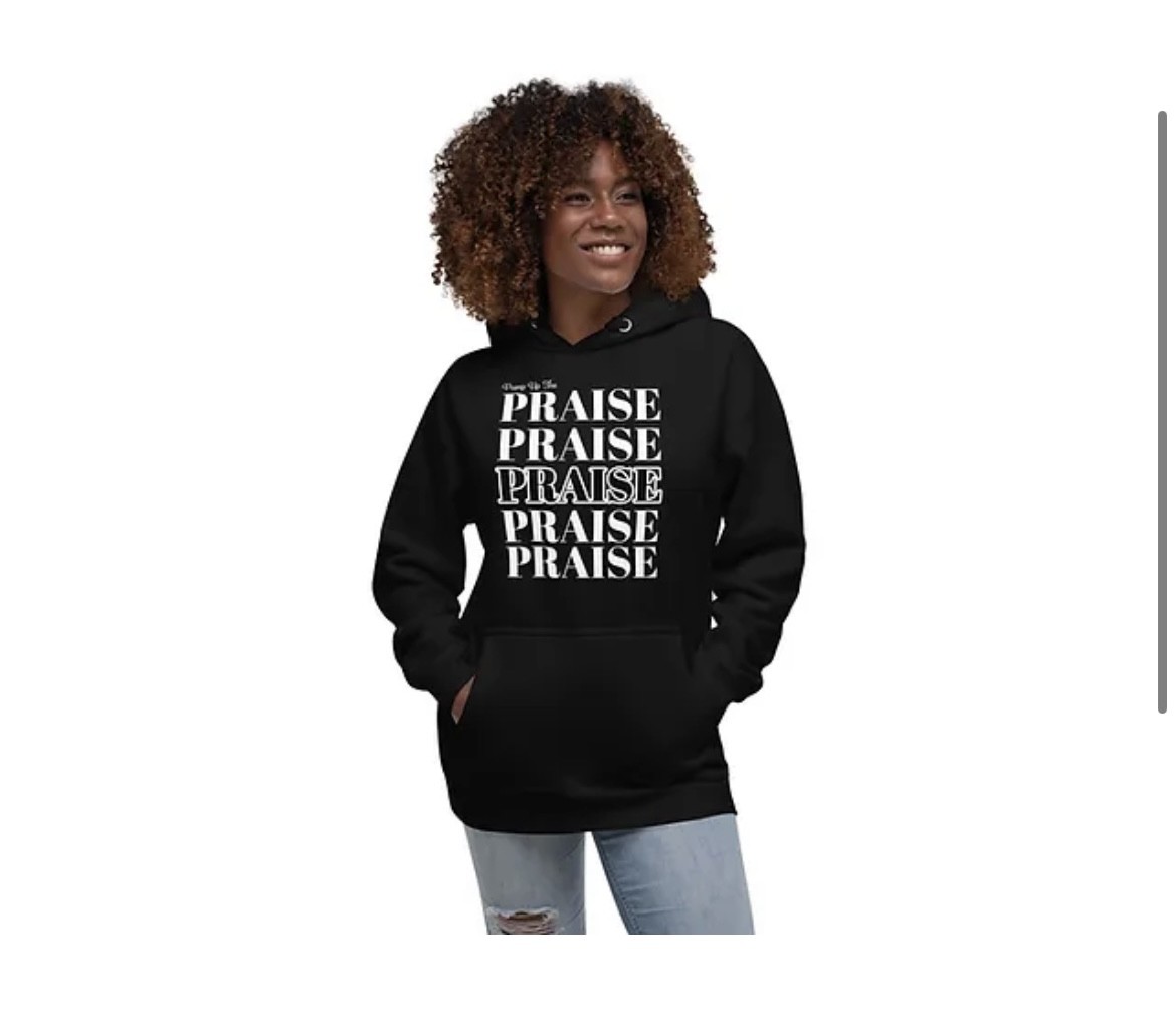 Black Praise Collection hoodie with stacked PRAISE print, worn by a woman
